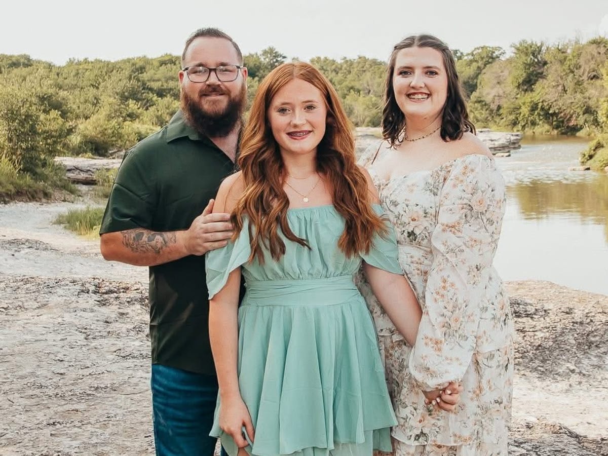 Gavin Reaves, founder of EZRV Travel, with his wife and daughter on the limestone riverbank of a Texas river